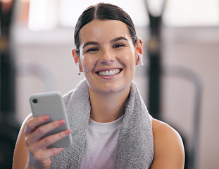 Image showing Gym, relax and portrait of happy woman with phone and headphones on workout break checking social media. Exercise, rest and person with smartphone for fitness app, music or networking for motivation.