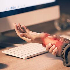 Image showing Woman, hands and wrist pain by computer from carpal tunnel syndrome or overworking at night by office desk. Hand of female holding painful arm area or pressure by PC from working late at workplace