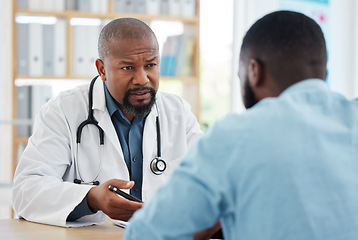 Image showing Doctor, serious black man and patient consultation in hospital for talking, checkup or results. Healthcare, medical professional and African person consulting physician for advice or cancer diagnosis