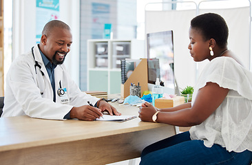 Image showing Doctor, writing on clipboard and consultation with black woman for health checkup. Healthcare, paperwork and happiness of medical professional with patient, checklist and results in hospital clinic.