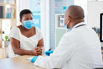 Image showing Doctor, patient and consulting with face mask for covid checkup, appointment or diagnosis at hospital. Black man, medical professional talking to woman in consultation or healthcare visit at clinic