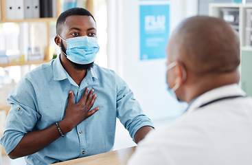 Image showing Doctor, chest pain and patient with covid in hospital for symptoms, breathing problem and consultation. Healthcare, sick black man and medical professional with face mask for treatment in clinic.