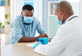 Image showing Doctor, covid and black man in consultation for results on clipboard in hospital. Healthcare, face mask and medical professional with paperwork talking with patient for health diagnosis or checkup.