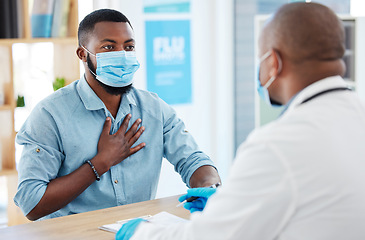 Image showing Doctor, chest pain and patient with covid in hospital for symptoms, examination and consultation. Healthcare, sick black man and medical professional with face mask for treatment or checkup in clinic