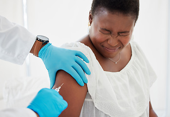 Image showing Doctor, black woman and vaccine injection with pain on arm for safety, immunity and prevention. Covid, healthcare and medical professional with vaccination, cure or medicine for sore person in clinic