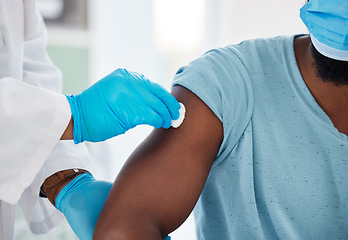 Image showing Doctor, hands and cleaning arm before vaccine for health, safety or prevention. Healthcare, covid and medical professional with cotton to disinfect shoulder of black man or patient before vaccination