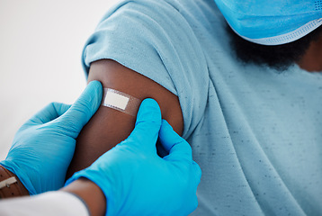 Image showing Doctor, hands and plaster on arm after vaccine with patient for safety, prevention and immunity. Healthcare, covid bandage and black man with medical professional after clinic vaccination in hospital