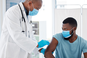 Image showing Doctor, black man and vaccine injection for covid safety, immunity and prevention. Face mask, healthcare and medical professional with vaccination syringe, cure or medicine for patient in clinic.