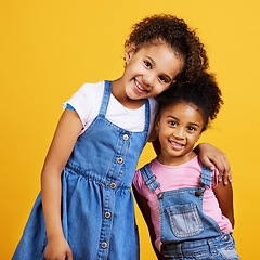 Image showing Children, smile portrait and happy sisters in studio with love, care and support of family on yellow background. Cute young girl kids or friends together for happiness, hug or trust with mockup space