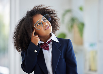 Image showing Thinking, smile and a girl dressed as an employee with a plan, idea or strategy in an office. Happy, cute and a little child playing pretend in business with a solution, thoughtful and ideas