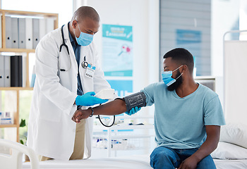 Image showing Doctor, covid and blood pressure with black man patient for heart health, test or examination. Healthcare, hypertension and person, medical professional or sphygmomanometer for consultation in clinic