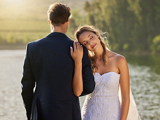 Image showing Affection, love and a couple at a lake wedding with comfort, content and celebration of marriage. Calm, peace and a man and woman embracing after a relationship commitment ceremony in nature