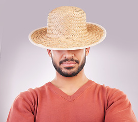 Image showing Man, hat and face in fashion style, hidden identity or profile standing isolated against a white studio background. Casual male model posing and wearing straw cap or stylish accessory covering eyes