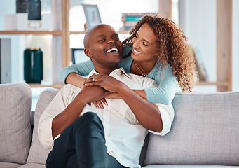 Image showing Couple, hug and laughing on sofa in home living room, bonding, relaxing and having fun. Interracial, love and funny black man and woman on couch embrace, happiness and enjoying quality time together