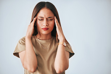 Image showing Headache, stress and woman in studio with anxiety, temple massage and pain on mockup background. Burnout, brain fog and girl suffering migraine, vertigo or dizzy, fatigue or frustrated by problem