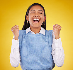 Image showing Happy, winner and yes with woman in studio for success, excited and celebration cheering. Wow, fist pump and achievement with female on yellow background for victory, promotion and good news