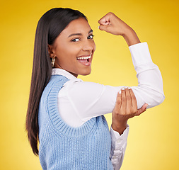 Image showing Arm, flex and portrait of woman in studio for winner, success and empowerment. Gender equality, satisfaction and champion with female on yellow background for pride, muscle strength and achievement