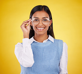 Image showing Glasses, happy and portrait of woman in studio for eyewear, vision and confidence. Optometry, nerd and happiness with female and spectacles isolated on yellow background for pride, young and eye care