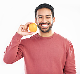 Image showing Orange fruit, happy man and portrait in studio, white background and wellness of healthy food. Smile, male model and vitamin c citrus for nutrition, organic juice and detox diet of raw ingredients