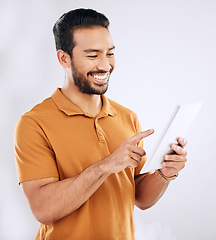 Image showing Man, tablet and smile in studio on social media, reading ebook and online website on white background. Happy male model, digital technology and connection for networking, search internet and download