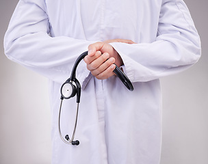 Image showing Medical, stethoscope and back with hands of doctor in studio for healthcare, cardiology and checkup. Medicine, support and expert with man on gray background for advice, heartbeat and consulting