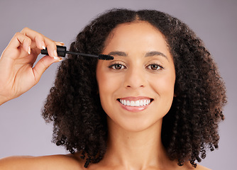 Image showing Happy woman, face and smile in portrait with mascara, beauty and makeup with cosmetic product on studio background. Female, cosmetology and eyelash extension with brush, happiness and cosmetics glow