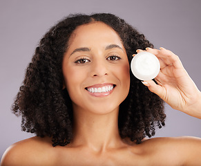 Image showing Happy woman, face and portrait smile for moisturizer, beauty or skincare against a gray studio background. Female smiling with teeth holding cosmetic product for healthy skin or soft facial treatment