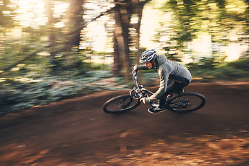 Image showing Fitness, cycling, and fast with man in nature for training, extreme sports and motion blur. Workout, race and speed with cyclist on bike in forest park for performance, challenge and adventure