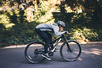 Image showing Cycling, nature and fitness with man in road for training, workout or cardio exercise. Adventure, extreme sports and speed with male cyclist on bike in forest park for performance, challenge or break