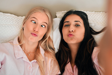 Image showing Funny, playful and portrait of women with a selfie for a memory, friendship or comic together. Goofy, silly and friends taking a photo in the bedroom during a sleepover being crazy and joyful