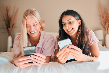 Image showing Teen friends, smartphone and girl on bed, relax and smile on face, social media scroll and happiness at home. Technology, young people chat on internet with gen z and phone app with meme online