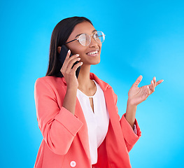 Image showing Happy business woman, phone call and conversation for communication or consulting against a blue studio background. Creative female employee talking on mobile smartphone in discussion for startup