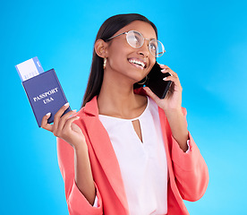 Image showing Happy woman, phone call and passport or ticket for travel, flight or USA documents against blue studio background. Female business traveler smile for international boarding pass talking on smartphone