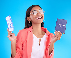 Image showing Happy woman, passport and ticket for travel, flight or USA documents against a blue studio background. Portrait of female business traveler smile holding international boarding pass or ID for trip