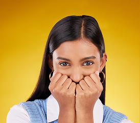 Image showing Portrait, wow and excited with a woman on a yellow background in studio looking shocked or in awe. Face, surprise and omg with an attractive young female standing hands over mouth in amazement