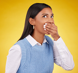 Image showing Shock, surprise and young woman in a studio with her hand on her mouth for a wtf expression. Shocked, ecstatic and Indian female model with wow or omg face for good news isolated by yellow background