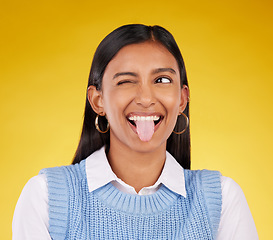 Image showing Funny, emoji and woman with tongue out, happy and cheerful against a studio background. Female, stress relief and girl with facial expression, humor and goofy action for joy, crazy and happiness