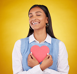 Image showing Satisfaction, paper and heart with woman in studio for love, support and romance. Valentines day, kindness and date with female and symbol mockup on yellow background for health, happiness and hope