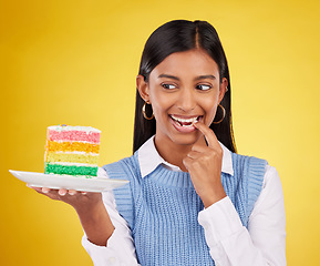 Image showing Birthday, diet and woman with cake in studio for happy celebration or party on yellow background. Happiness, excited gen z model with rainbow dessert on plate to celebrate milestone or achievement.