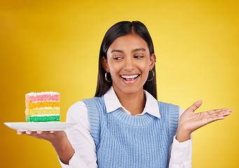 Image showing Birthday, smile and woman with cake in studio for happy celebration or party on yellow background. Happiness, excited gen z model with rainbow dessert on plate to celebrate milestone or achievement.