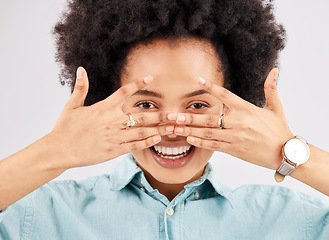 Image showing Portrait, hiding face woman and smile in a studio with a person feeling playful or joking for comedy. Eyes, smile and hand gesture with a funny young female looking happy with a positive attitude