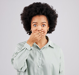 Image showing Portrait, hand and wow with a shocked woman in studio on a gray background feeling surprised by gossip. Face, mouth or afro and a young female hearing news with an omg or wtf expression of disbelief