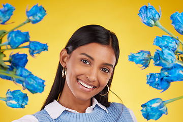 Image showing Portrait, love and blue roses with a woman on a yellow background in studio for valentines day. Face, flowers or smile and a happy female posing with plants for anniversary, romance or celebration