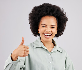 Image showing Portrait, thumbs up and black woman laughing in studio isolated on a white background. Success, happiness and person with hand gesture or emoji for winning, approval or agreement, like or thank you.