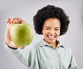 Image showing Portrait, apple and black woman smile in studio isolated on a white background. Food, fruit and happiness of person with vitamin c, nutrition or healthy diet, wellness or nutritionist, vegan or detox