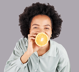 Image showing Portrait, orange and black woman with fruit in studio isolated on a white background. Food, top view and happiness of person or female with vitamin c, nutrition or healthy diet, citrus or vegan detox