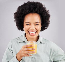 Image showing Portrait, smile and orange juice with a laughing woman in studio on a gray background for health or vitamin c. Face, drink and glass with a happy young female drinking a fresh beverage for nutrition