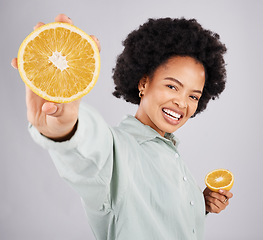 Image showing Portrait, orange and black woman smile with fruits in studio isolated on a white background. Food, nutritionist or happiness of person with vitamin c, nutrition or healthy diet, citrus or vegan detox