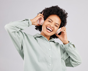 Image showing Portrait, music headphones and black woman singing in studio isolated on white background. Singer, radio and happiness of person listening, streaming and enjoying audio track, sound album or podcast.