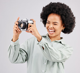 Image showing Laughing, camera photographer and black woman in studio isolated on a white background. Photography, professional and funny person or female ready to start filming, photoshoot or taking picture.